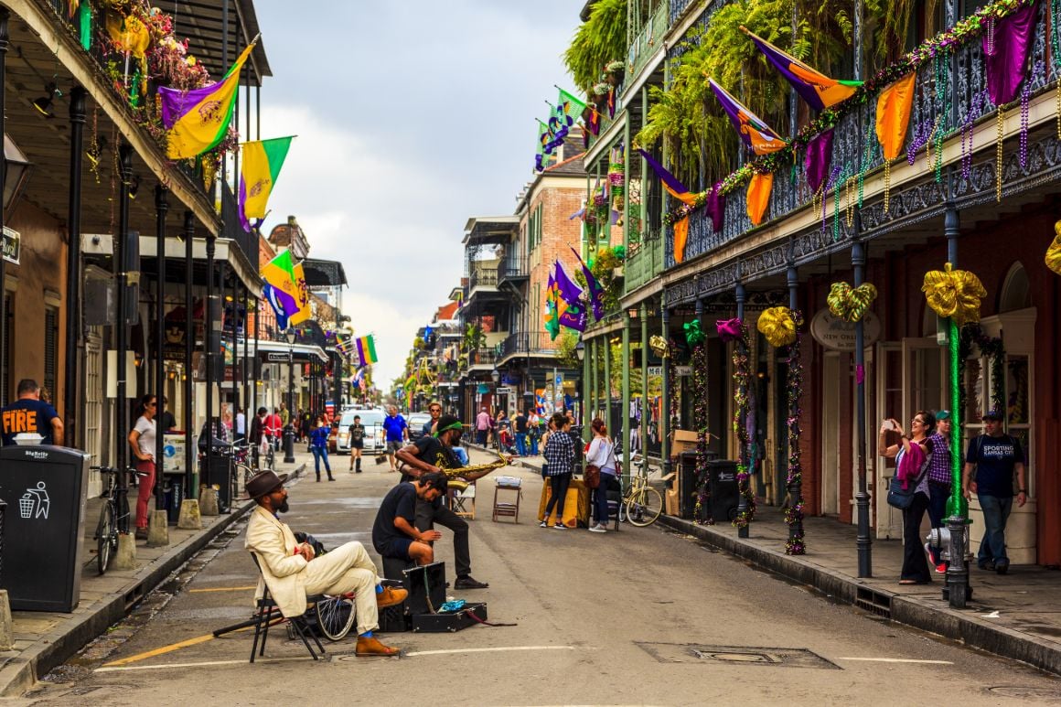 guys sitting on street talking in new orleans during mardi gras