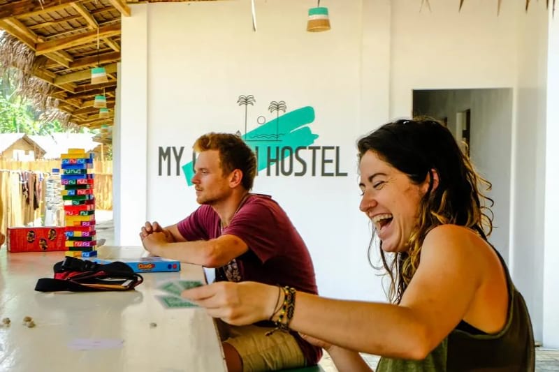 A girl playing cards at a very safe hostel