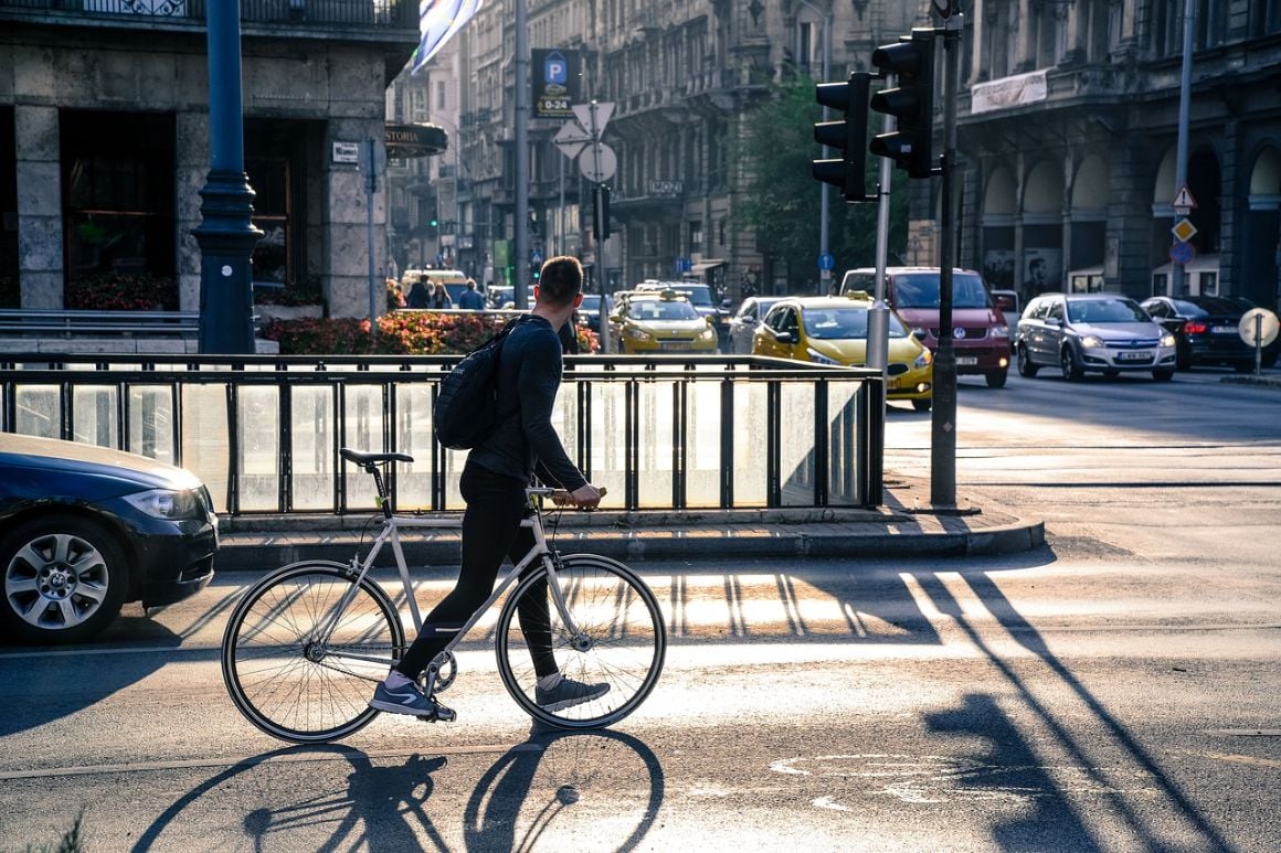 Man riding a bike through Budapest roads