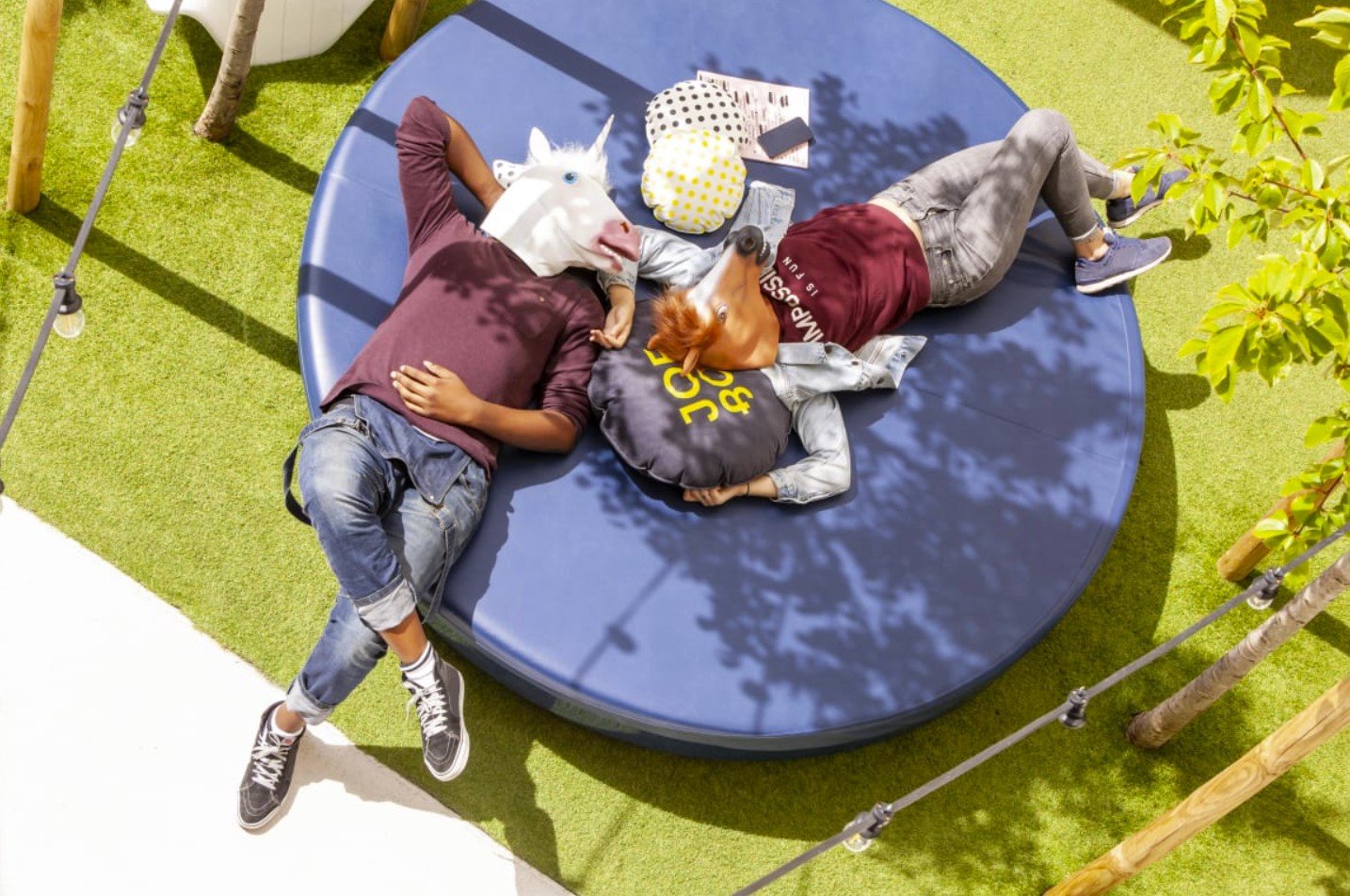 Two backpackers with horse masks wondering what a hostel is