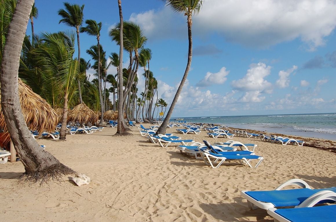 blue beach chairs on a beach in punta cana in the dominican republic