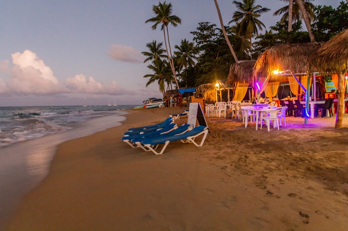 beach chairs and a beachside cafe in Las Terrenas in the dominican republic around sunset