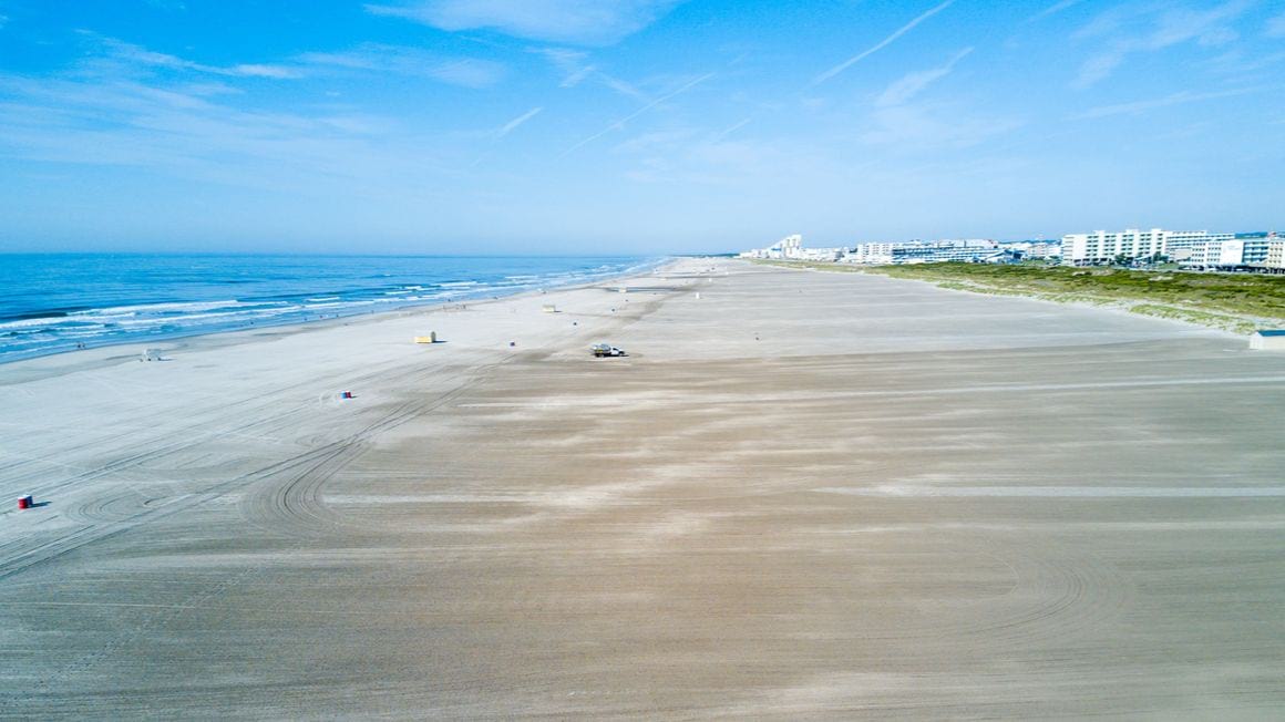 Long white sand Beach with blue skies and blue waters at Wildwood Crest Cape May