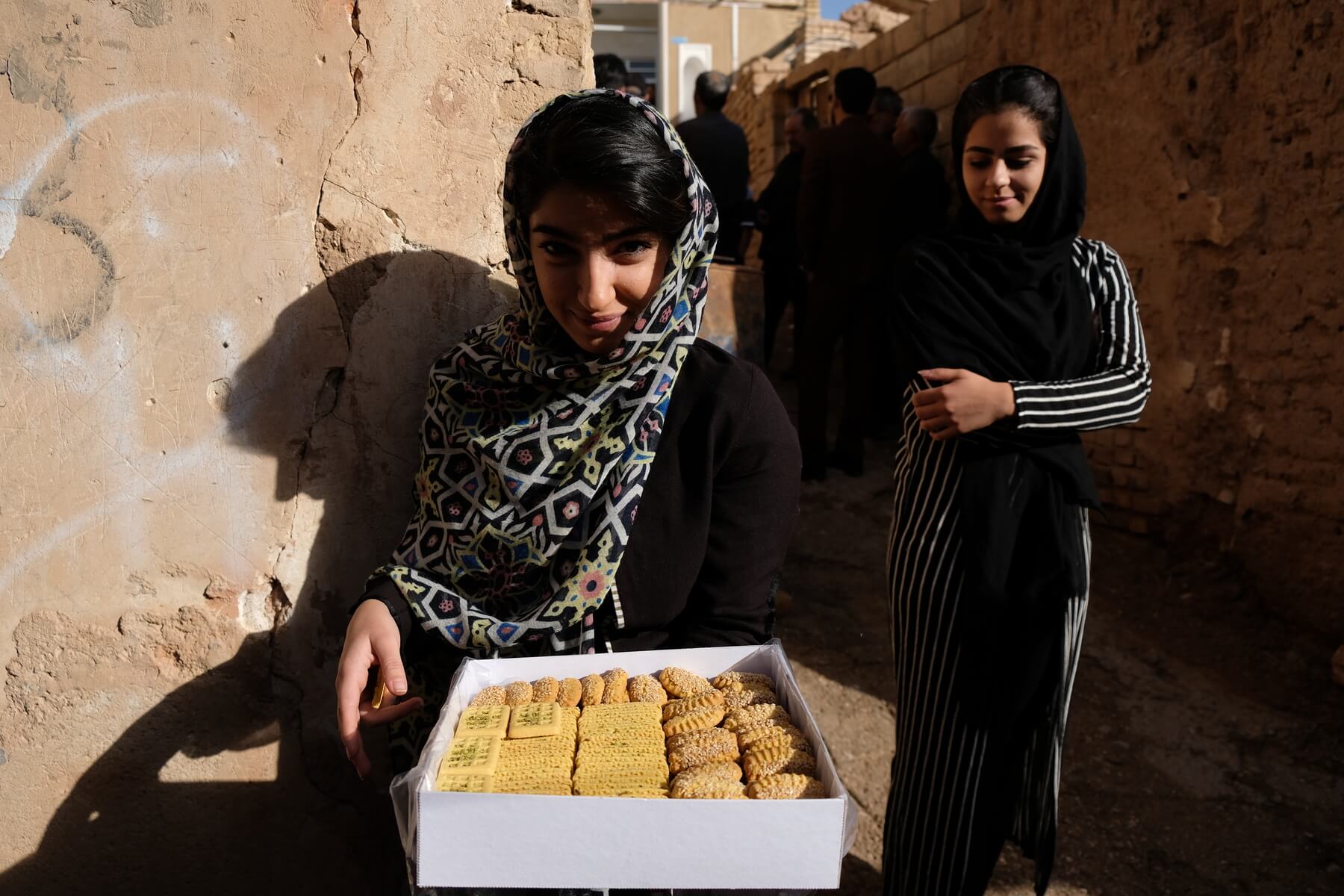 Two Persian woman offering an offbeat traveller some sweets