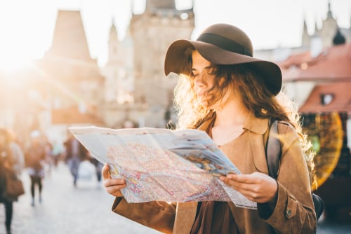 solo female backpacker looking at a map