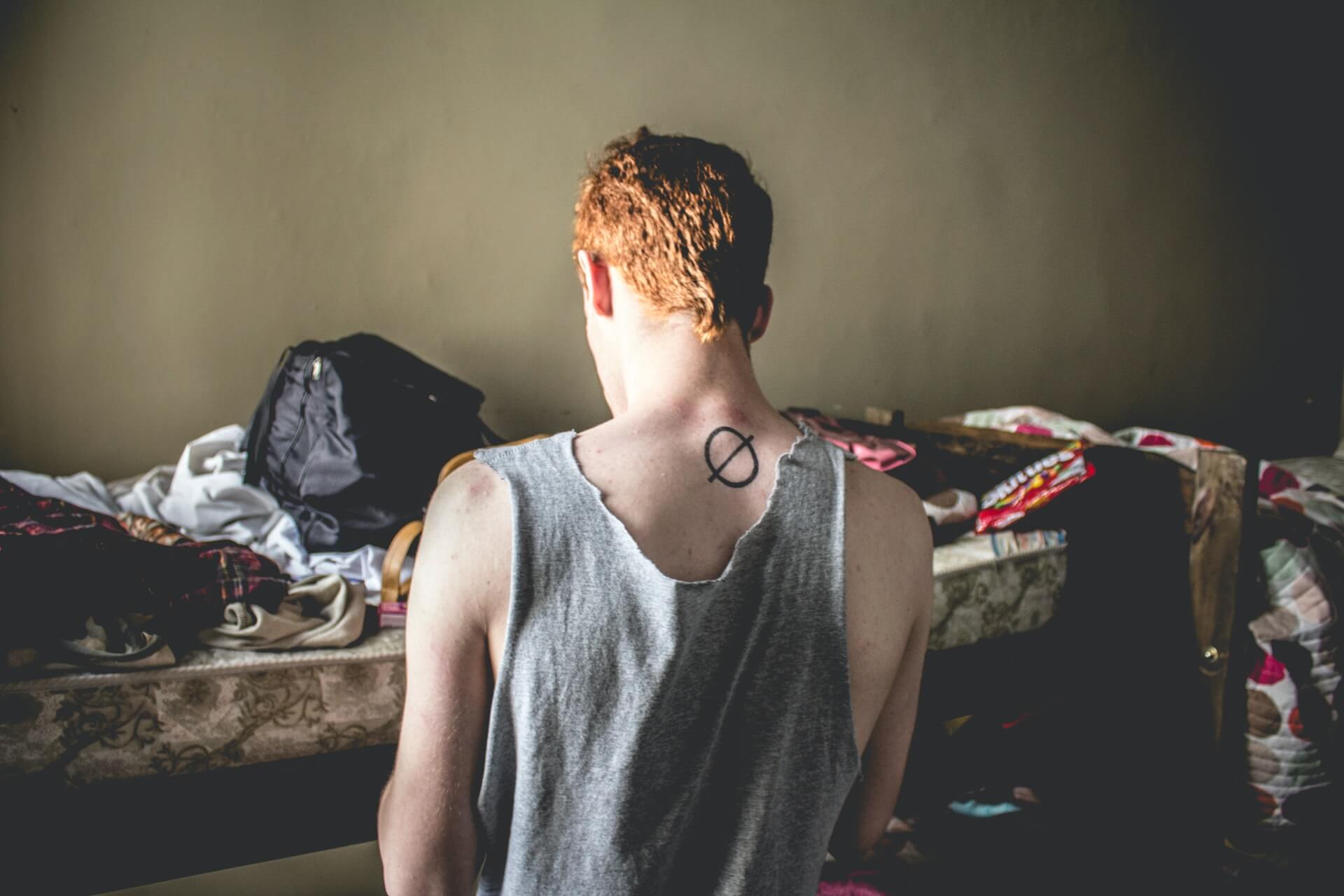 A kid packing his stuff after staying in a youth hostel