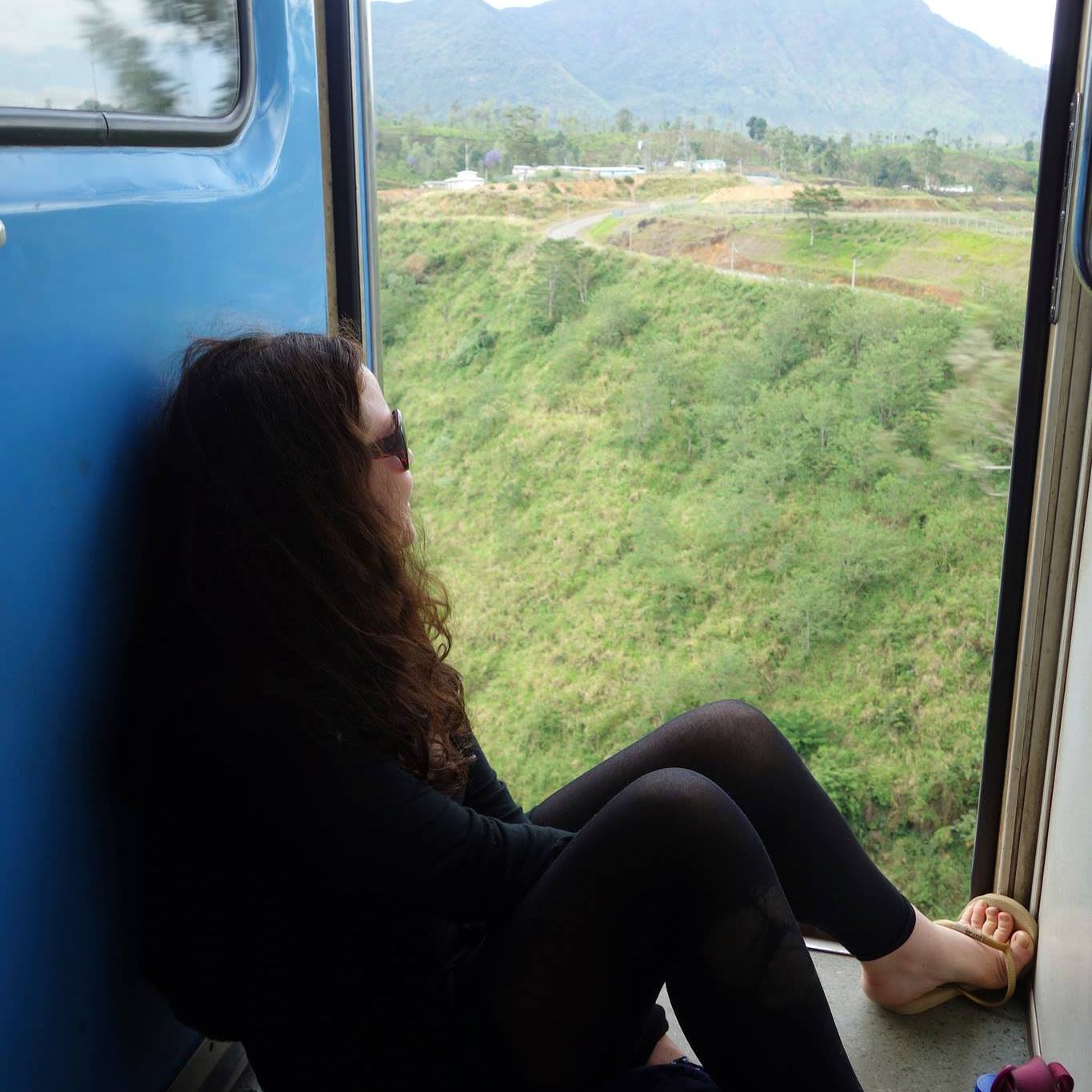 Clair sitting in a train looking out