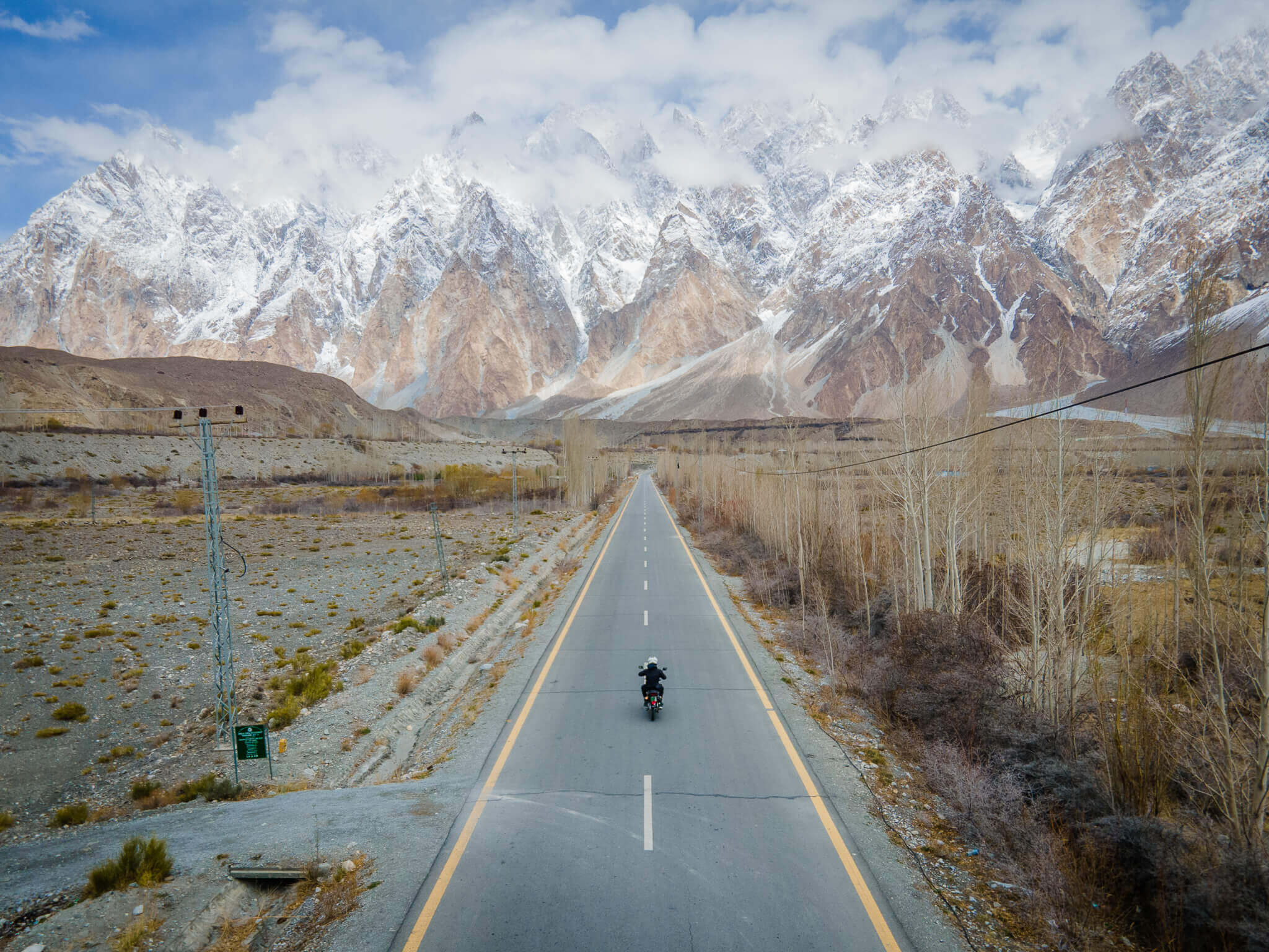 motorbiking in pakistan beneath the hunza valley's massive passu cones
