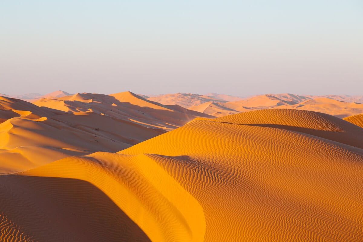 stunning orange-tan sand dunes in the empty quarter of oman