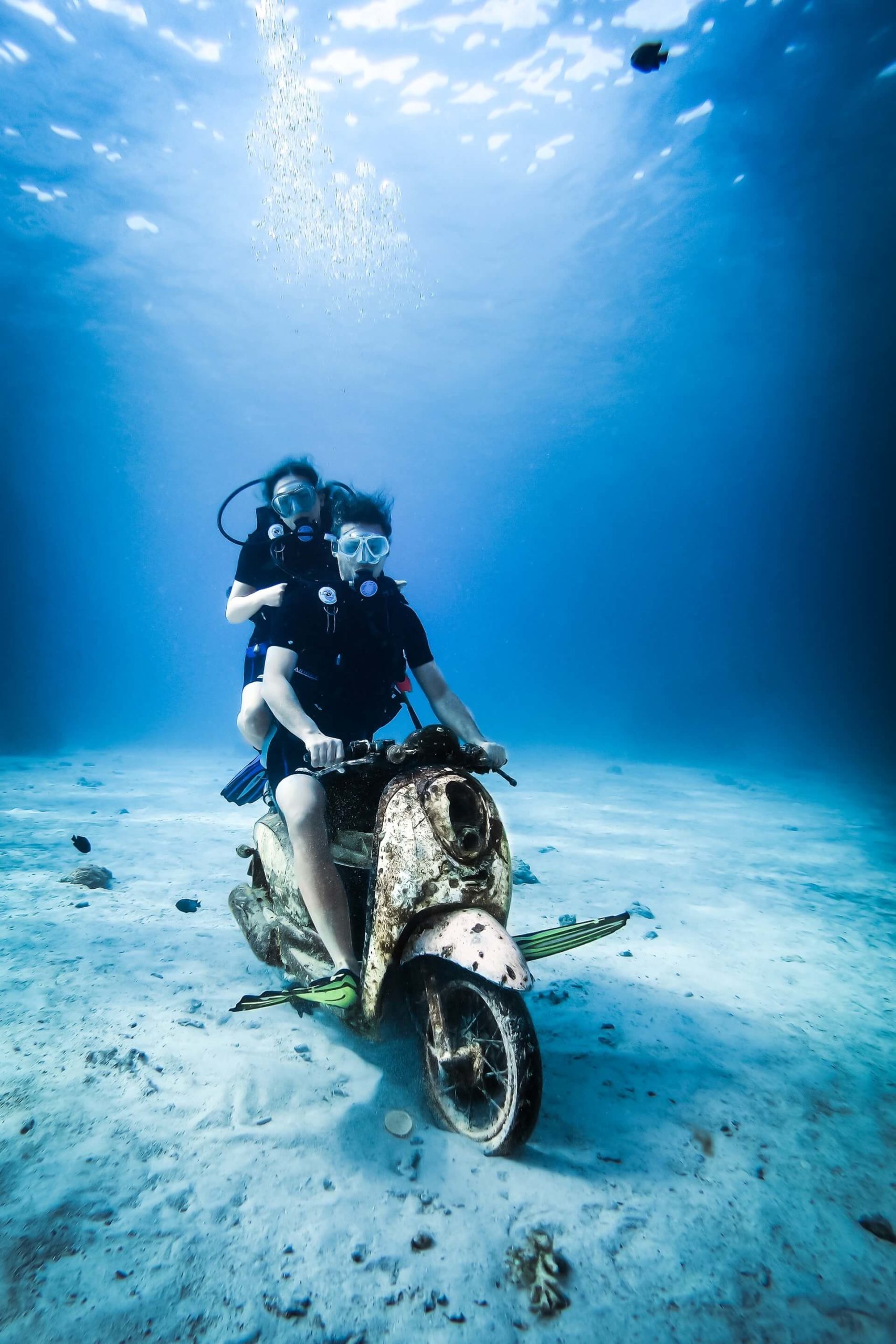 Two divers in New Zealand pulling some shenanigans on a submerged motorbike.