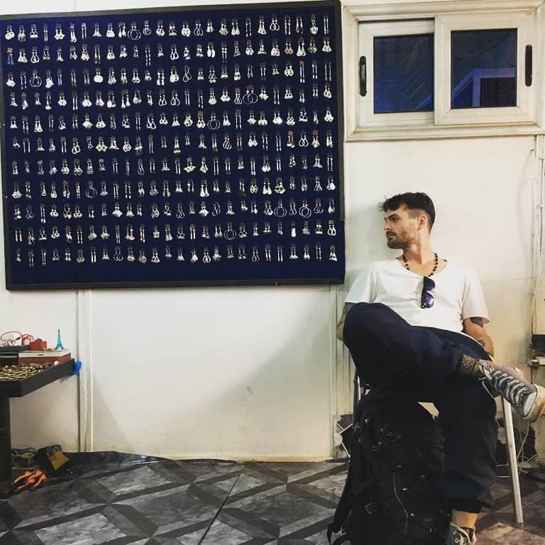 Aiden sitting next to a jewellery display