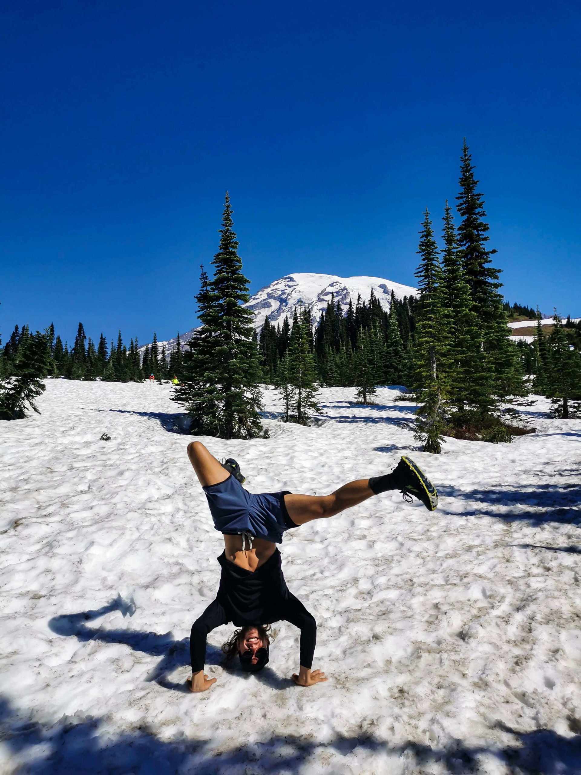 Art doing a handstand in a beautiful snowy landscape