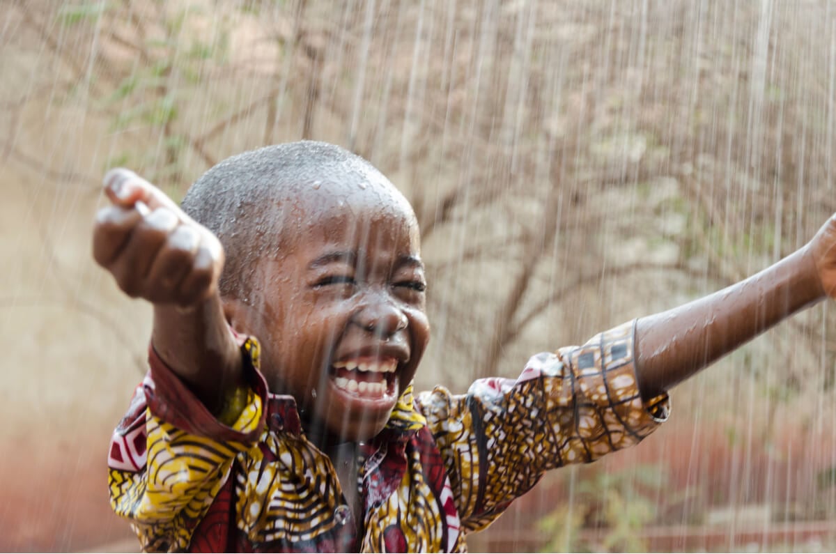 A very happy kid to receive the rains in Kenya