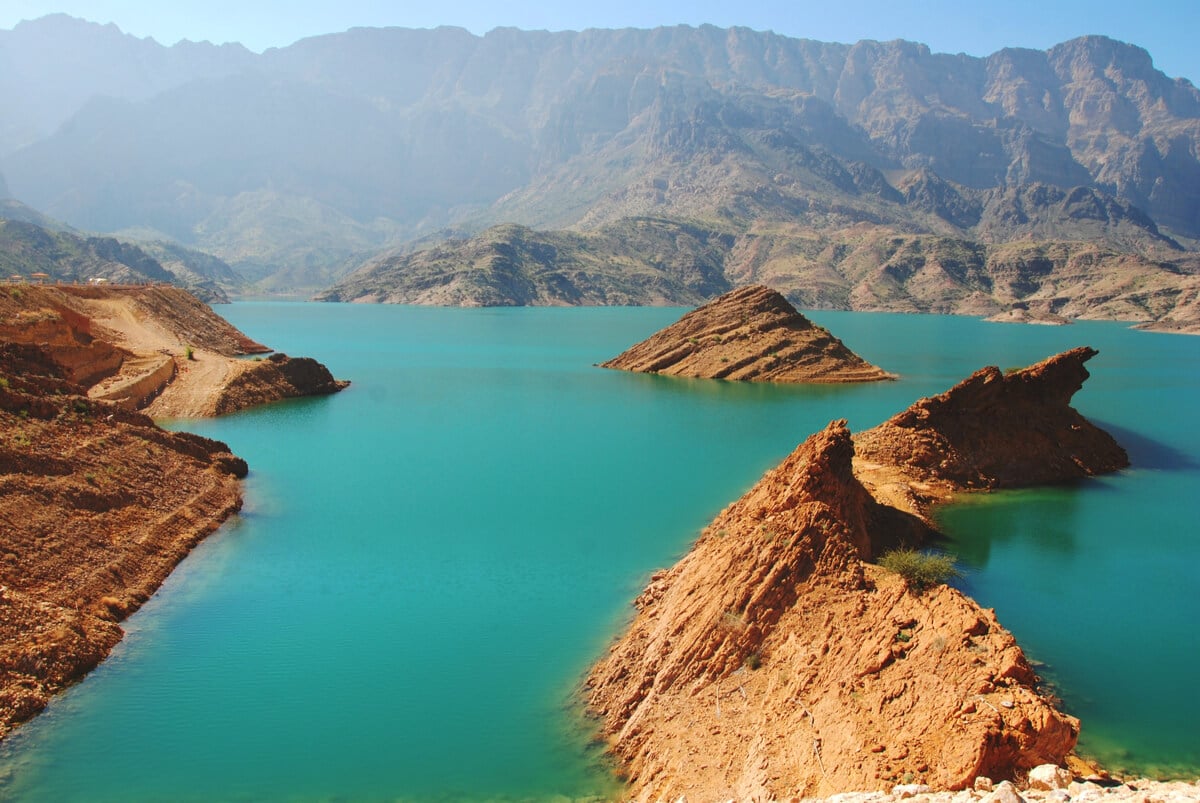 aerial shot of the turquoise waters and rock formations of wadi dayqah dam