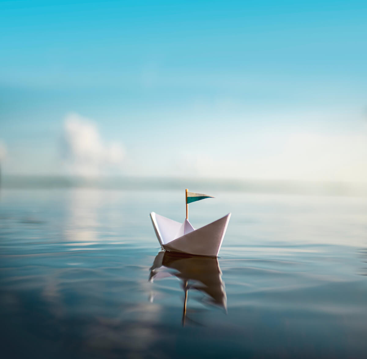 A paper sailboat on water.