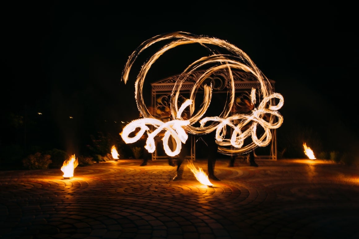 French Polynesian performers spin fire at night. 