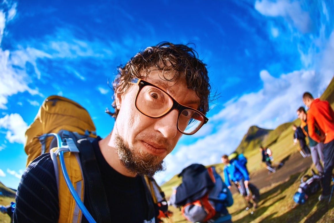 A hiker who has not had enough water stares wildly into the camera.