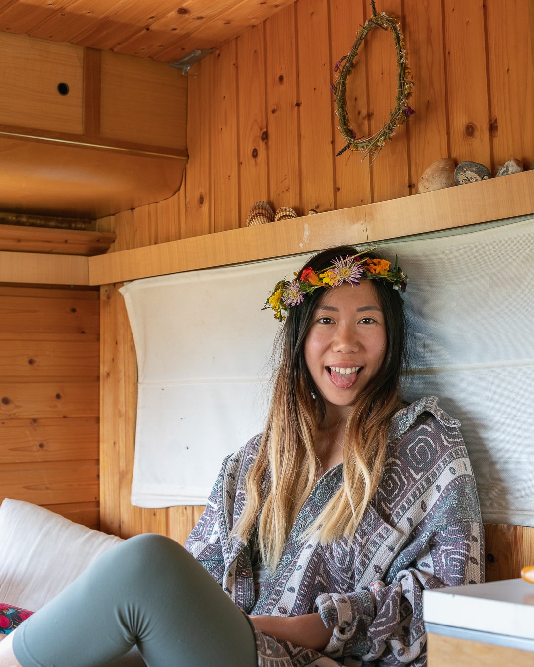 Marsha jean smiling at the camera with a wreath of flowers on her head.