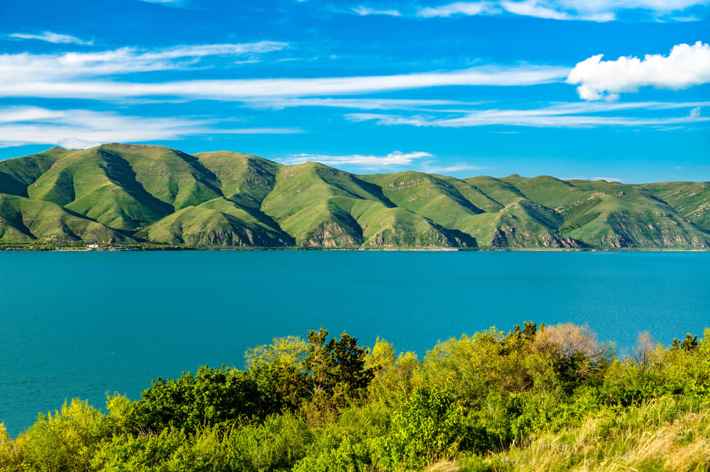 lake surrounded by greenery and hills