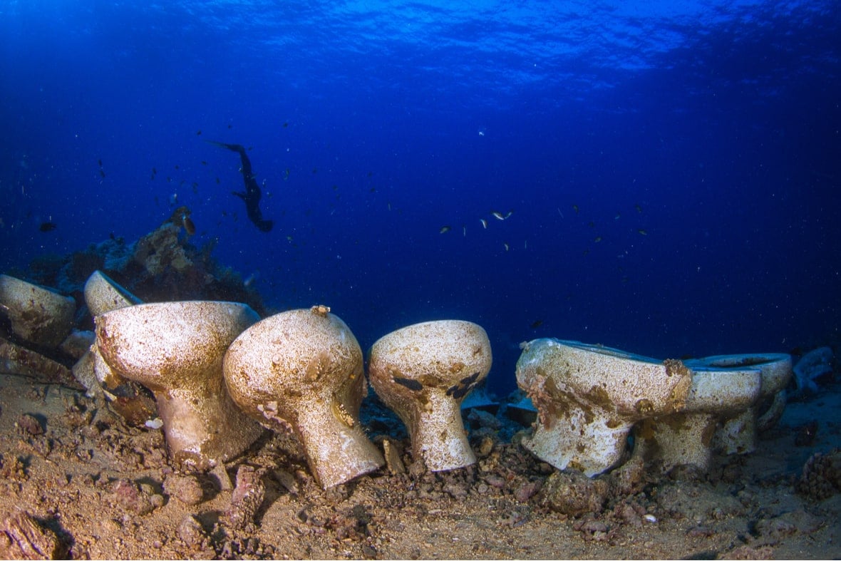 Four underwater toilets looking gross as a reminder to sailors that how you poop on a boat is important. 