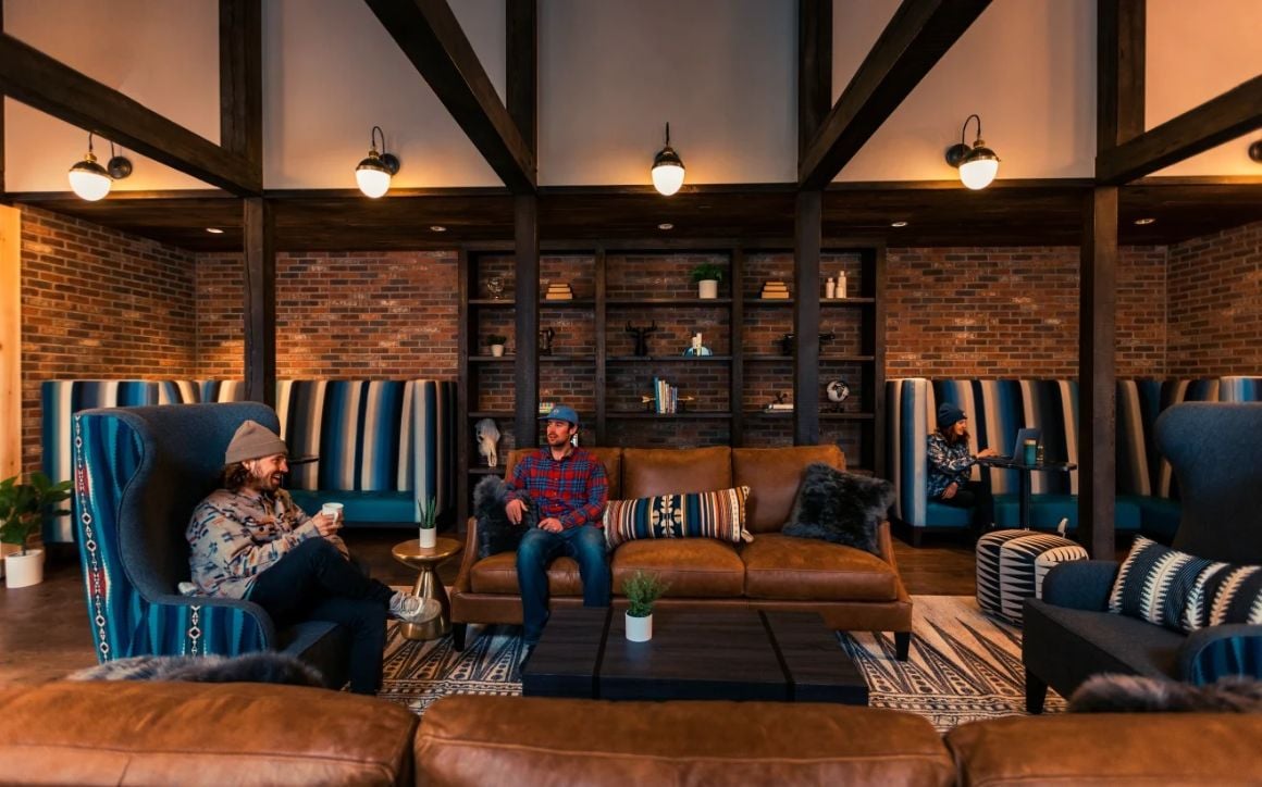 Two men sit in a hostel common area and talk about life on the raod in oceania