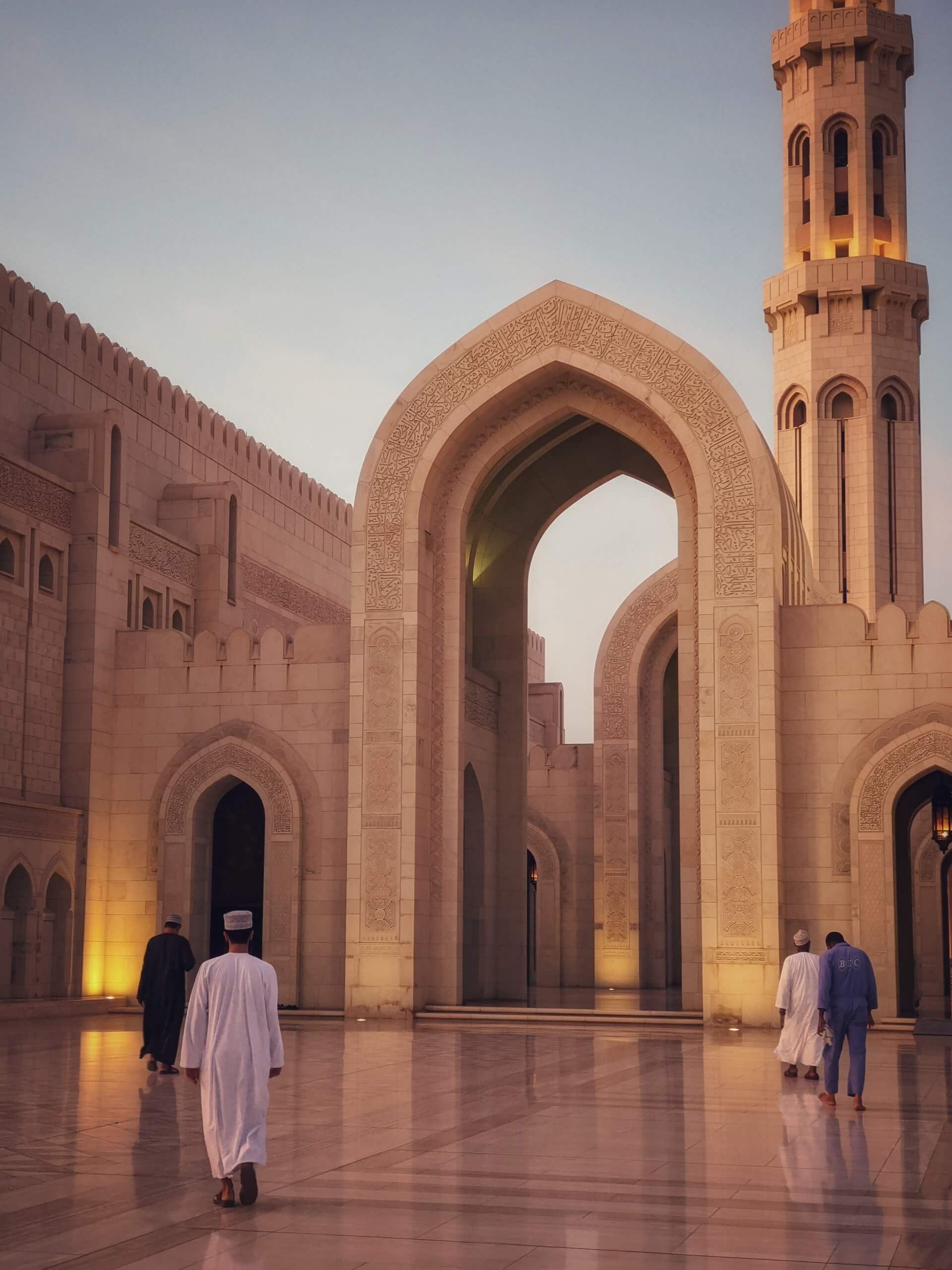 Several Omani men attending prayer at the Sultan Qaboos Mosque