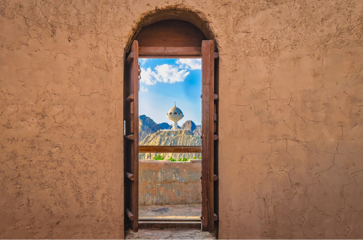 A window looking out at a famous tourist attraction in Oman