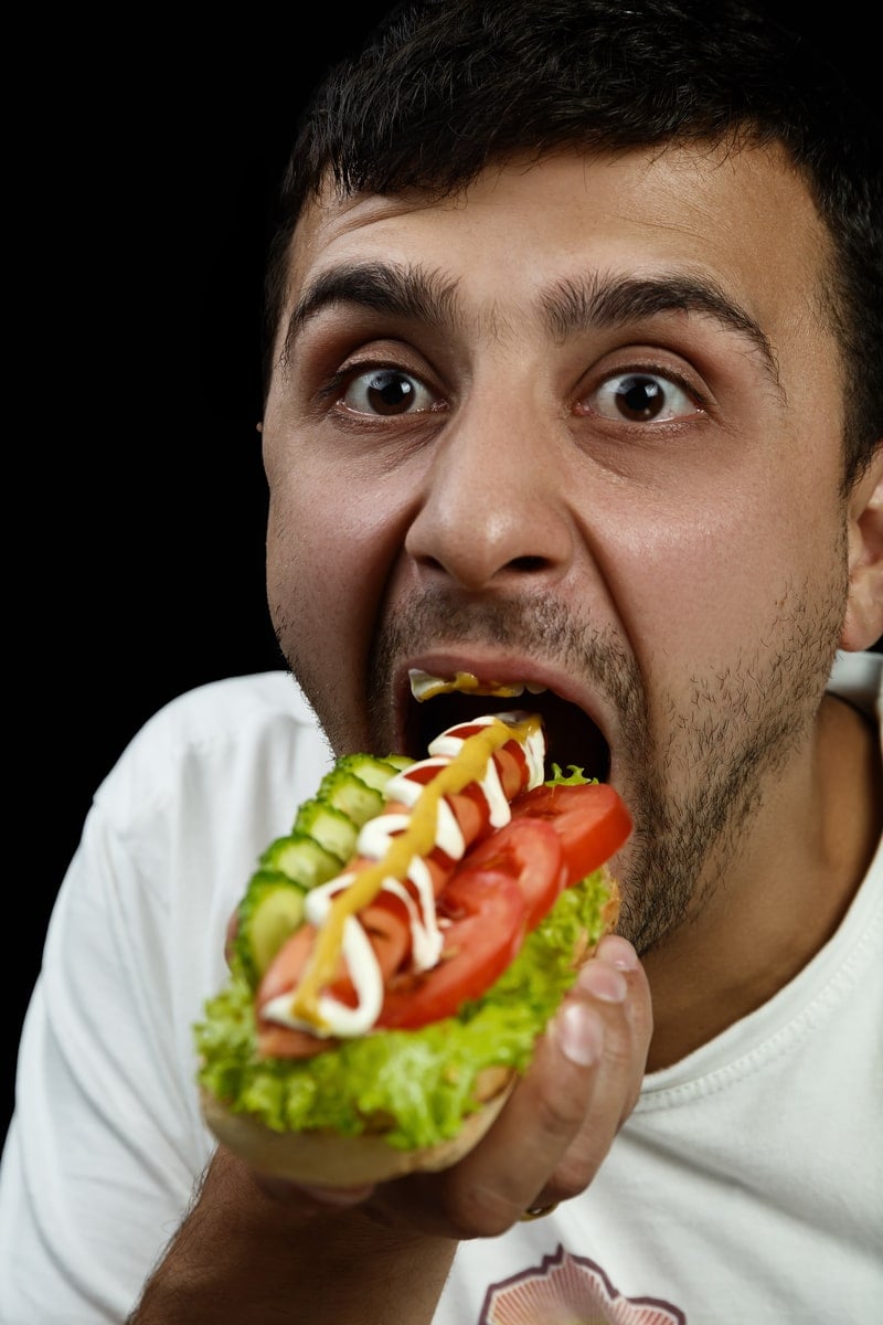 A man eats very messily.