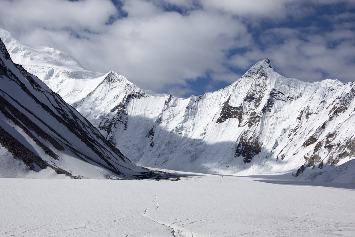 massive white mountains towering over a sea of snow in pakistan
