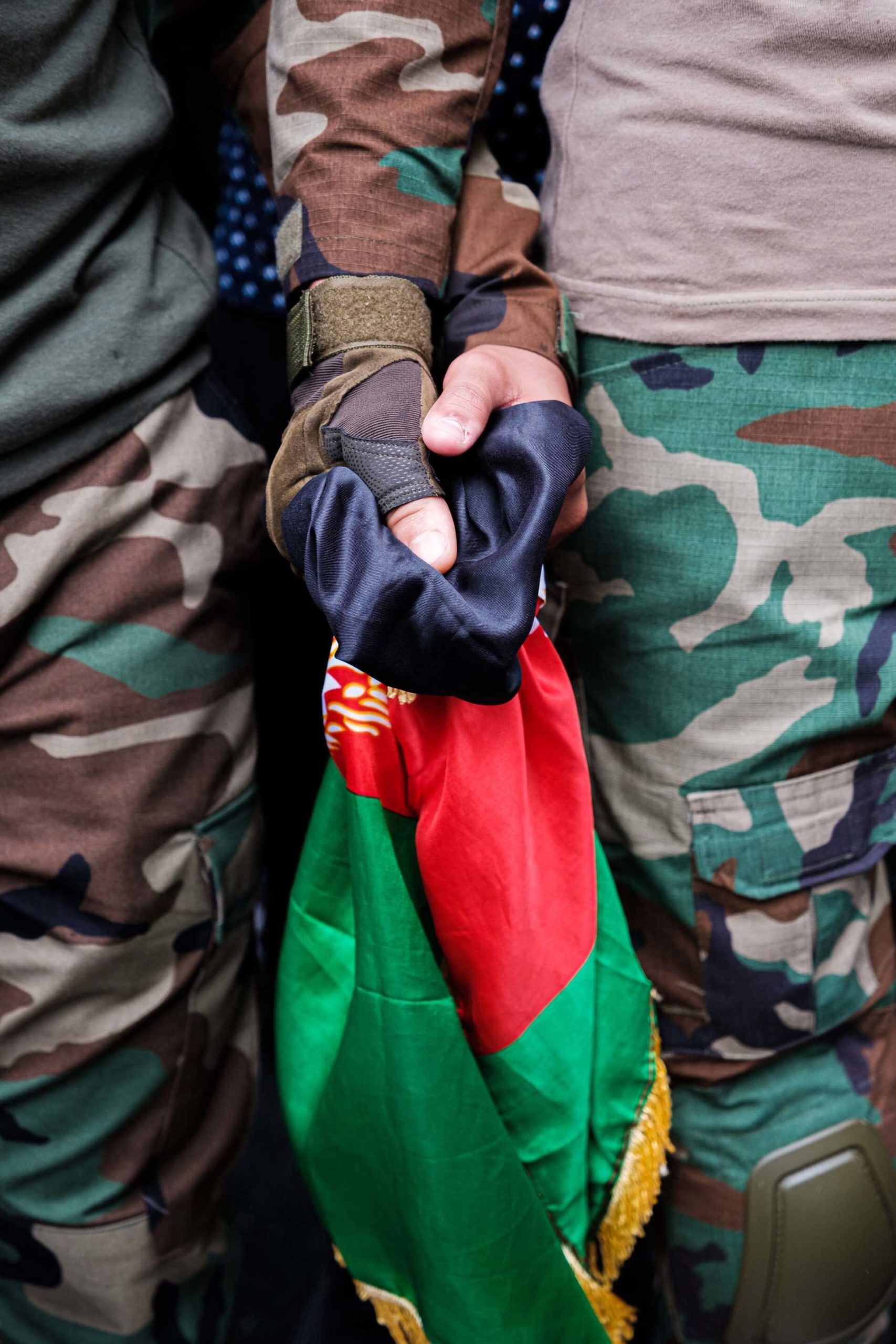 Two protesters in Londo hold hands showing solidarity with Afghanistan.