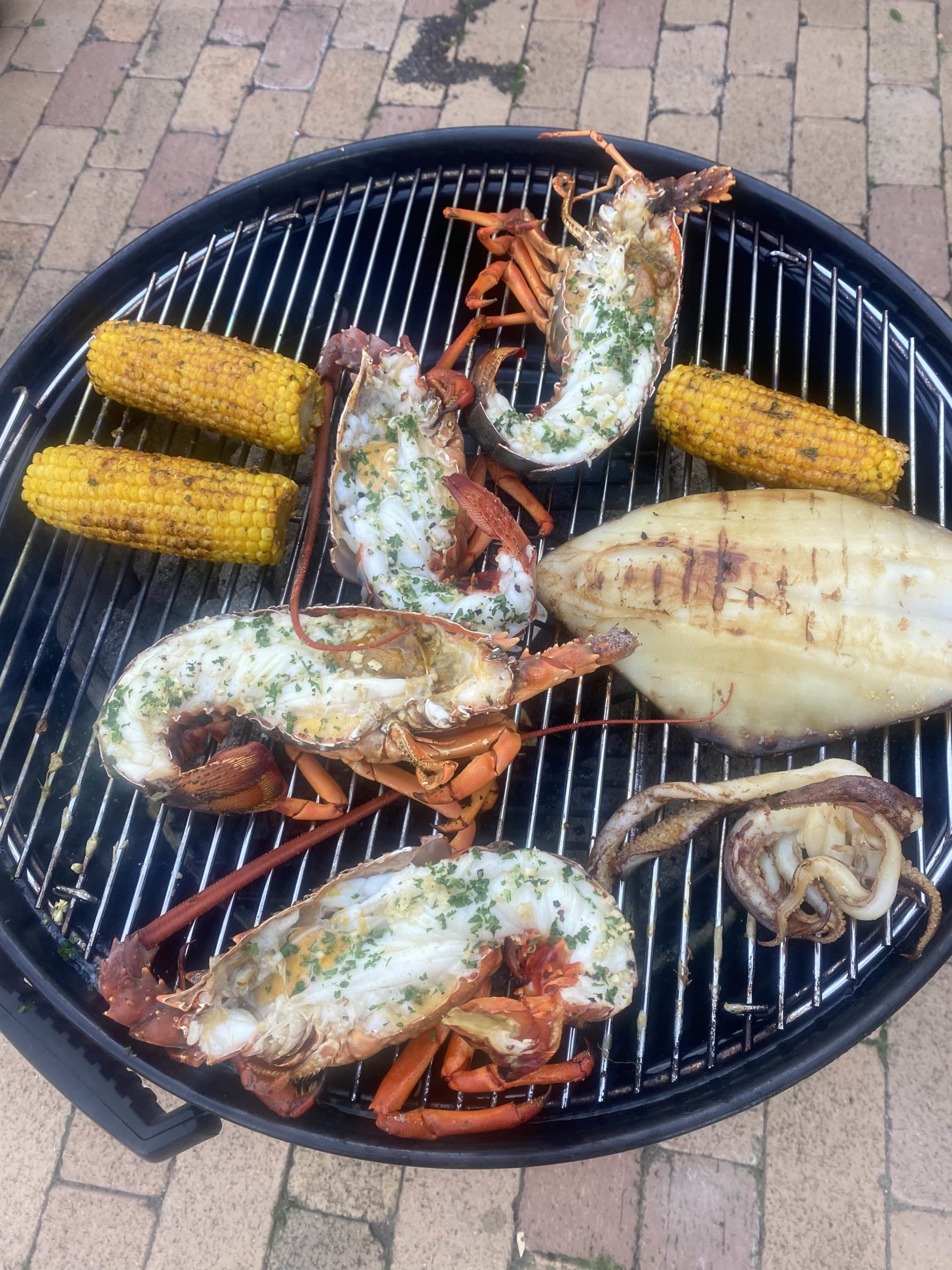 fresh lobster, corn and fish on the barbecue. 