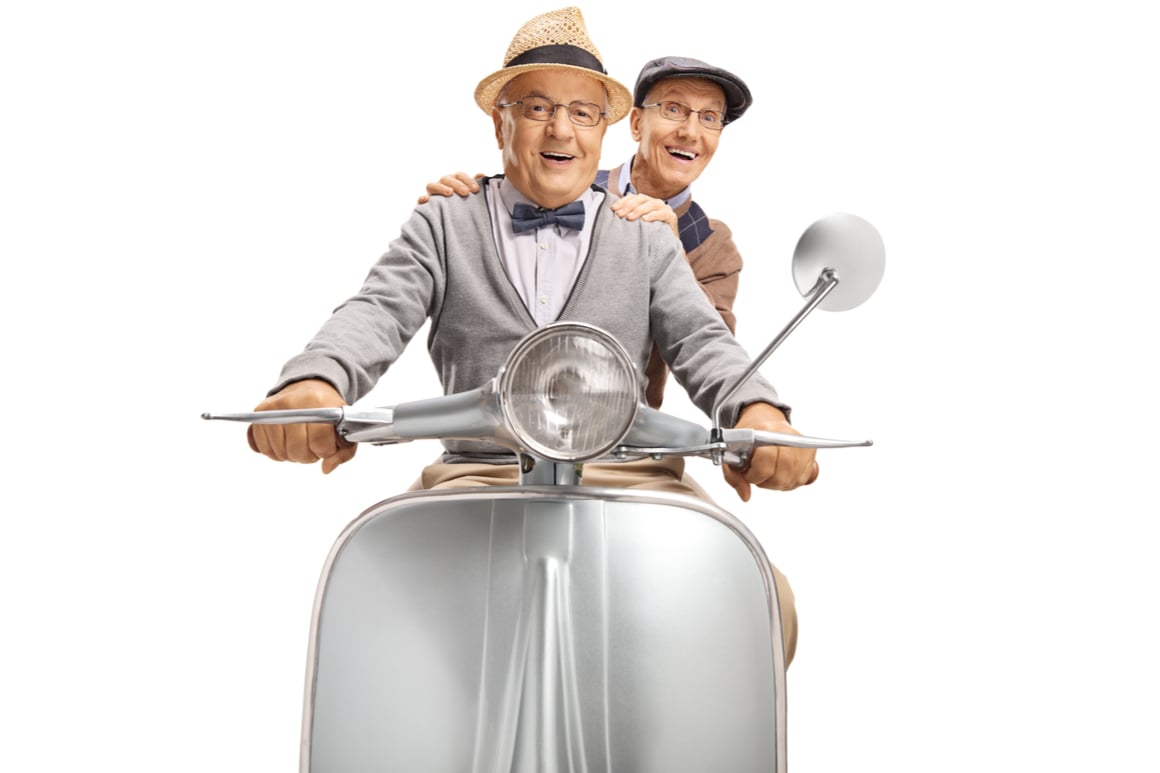 Two old men on a motorbike travelling together while gay