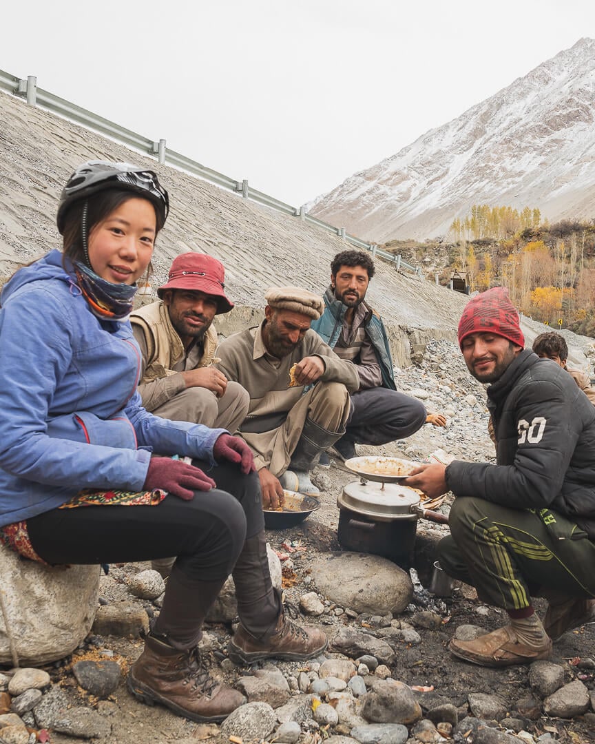 Marsha enjoys a roadside lunch with some locals during her bike tour in Pakistan.