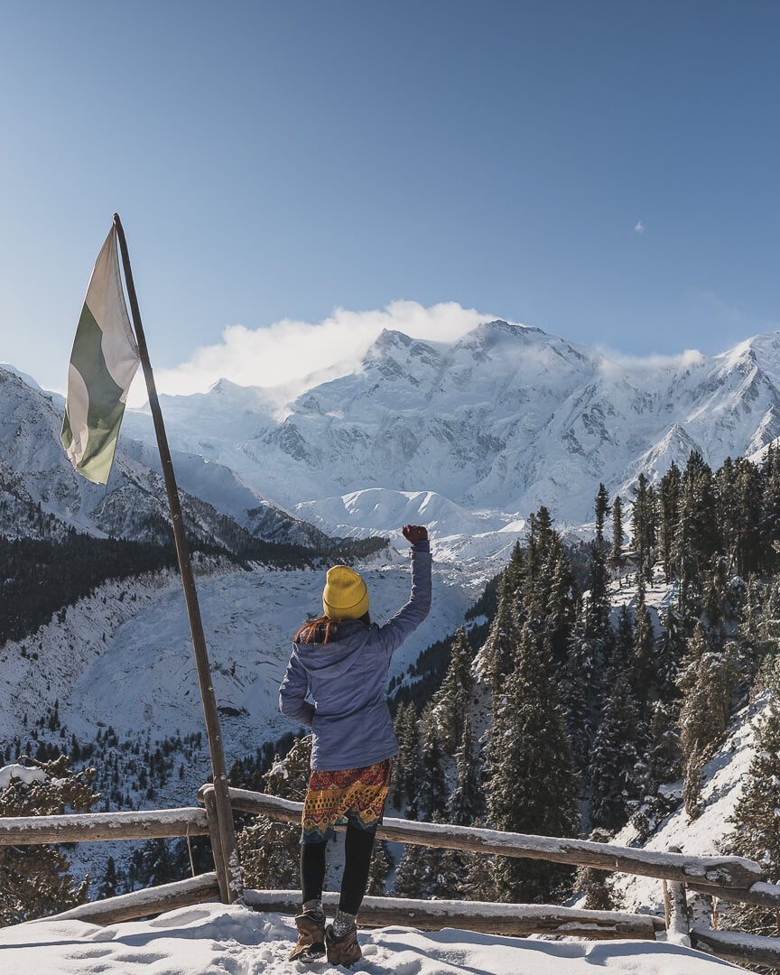 Marsha Jean at a lookout in Pakistan cheering at the view of Nanga Prabat.