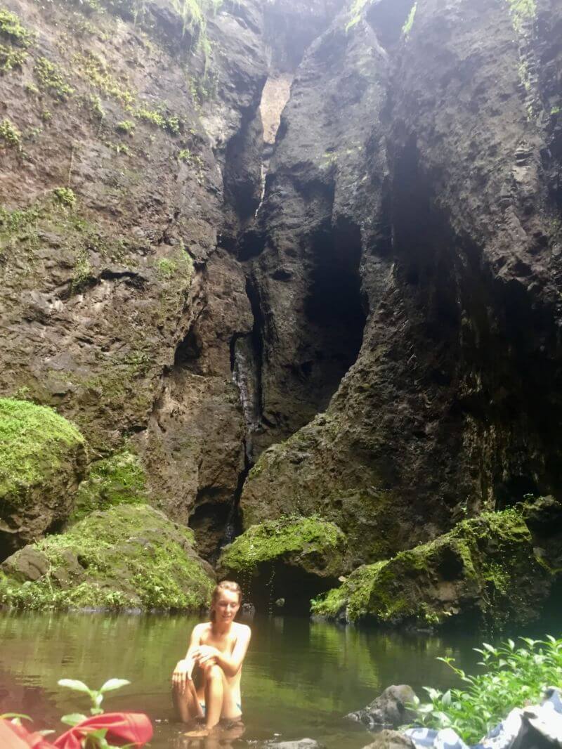 A girl sits in the forest of French Polynesia