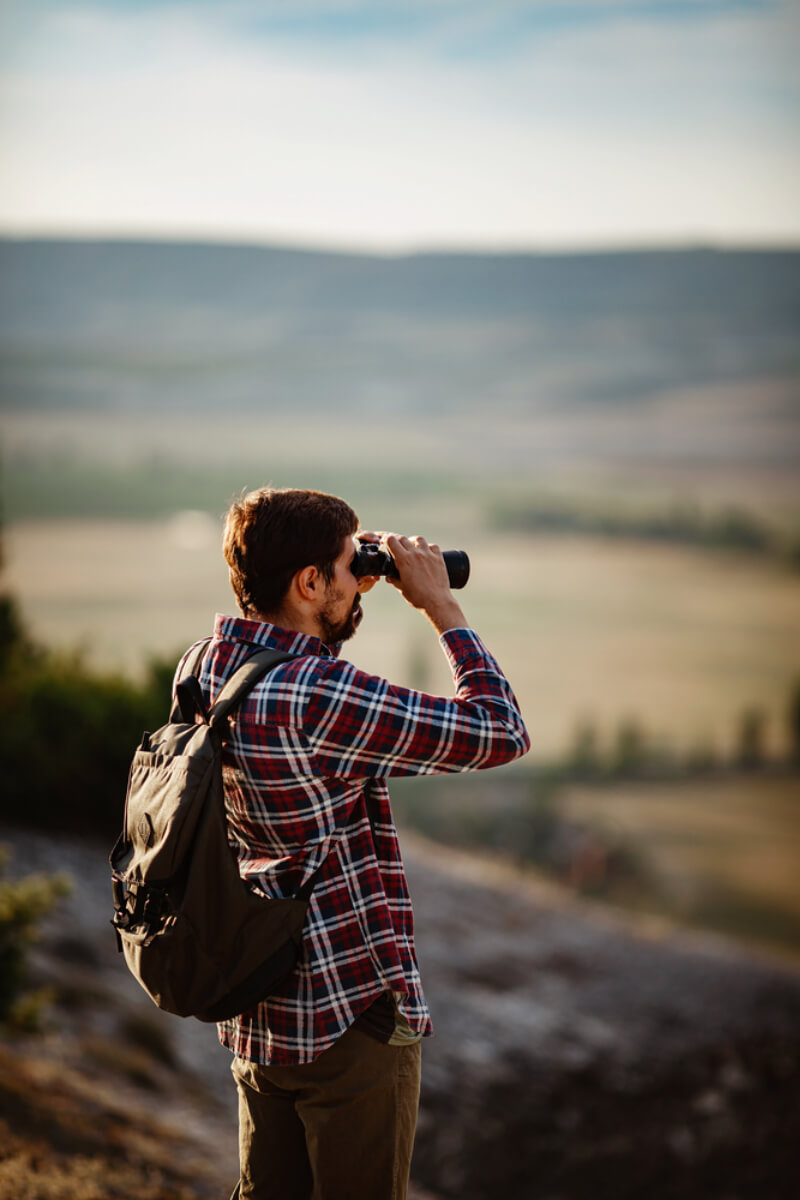 backpacker binoculors searching