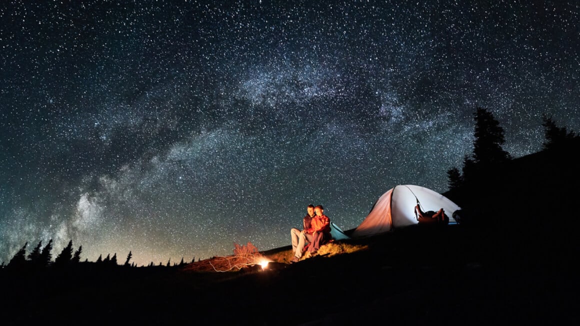 couple camping under the stars