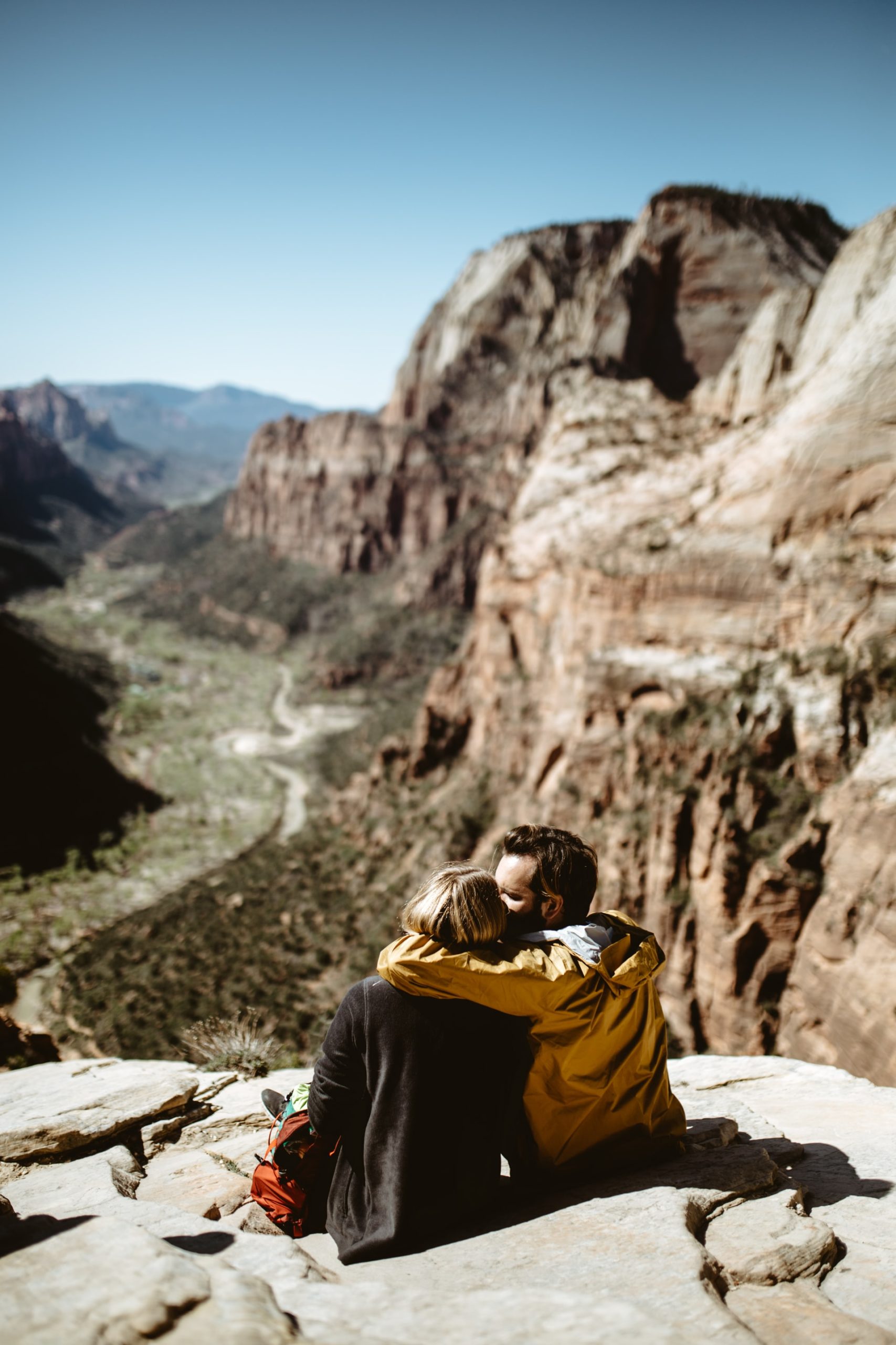 couple kissing on a rock while traveling as a couple