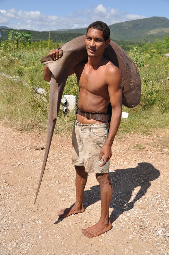 A man carries a fish over his shoulder in Florida