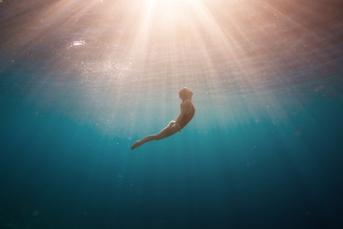 freediving 101 woman diving and approaching the surface