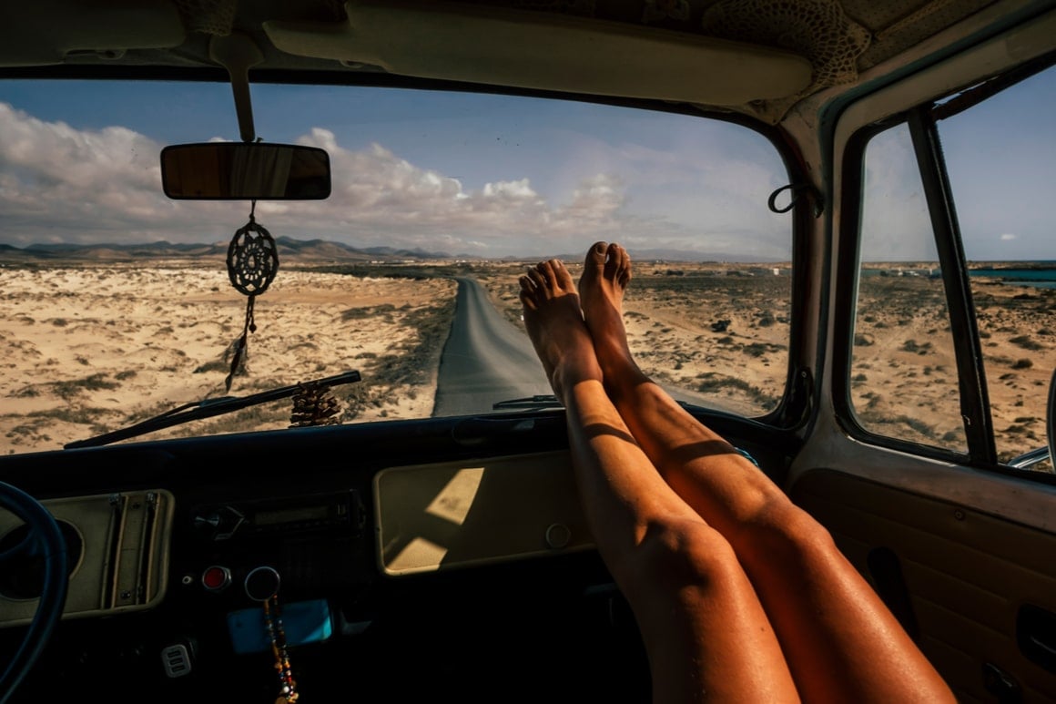 feet in front seat of a van backpacking usa