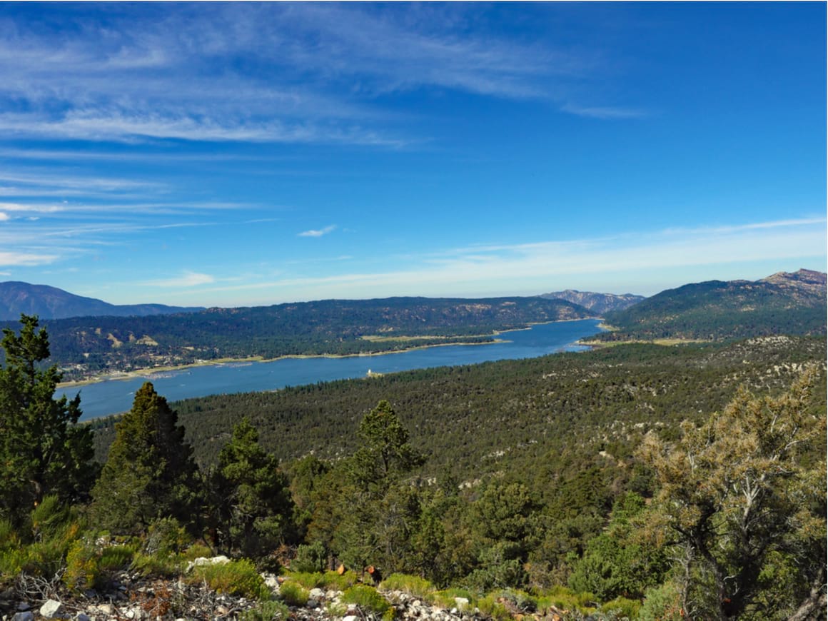 A view from Cougar Crest Trail Big Bear looking towards the lake with blue skies overhead