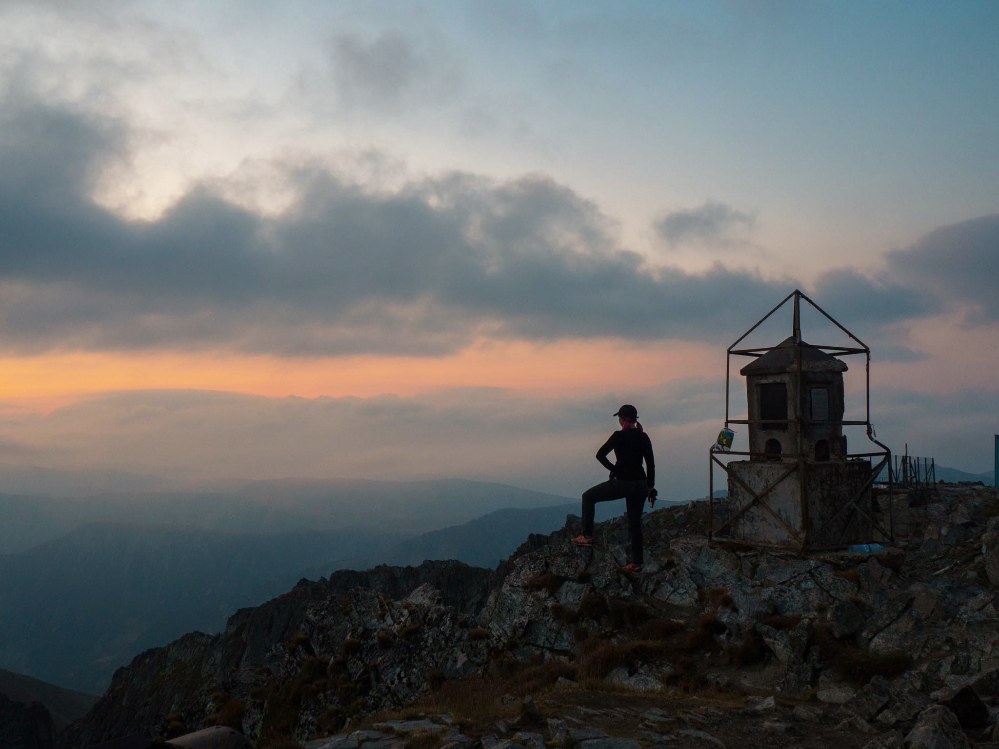 hiker on top of the mountain looking at sunrise