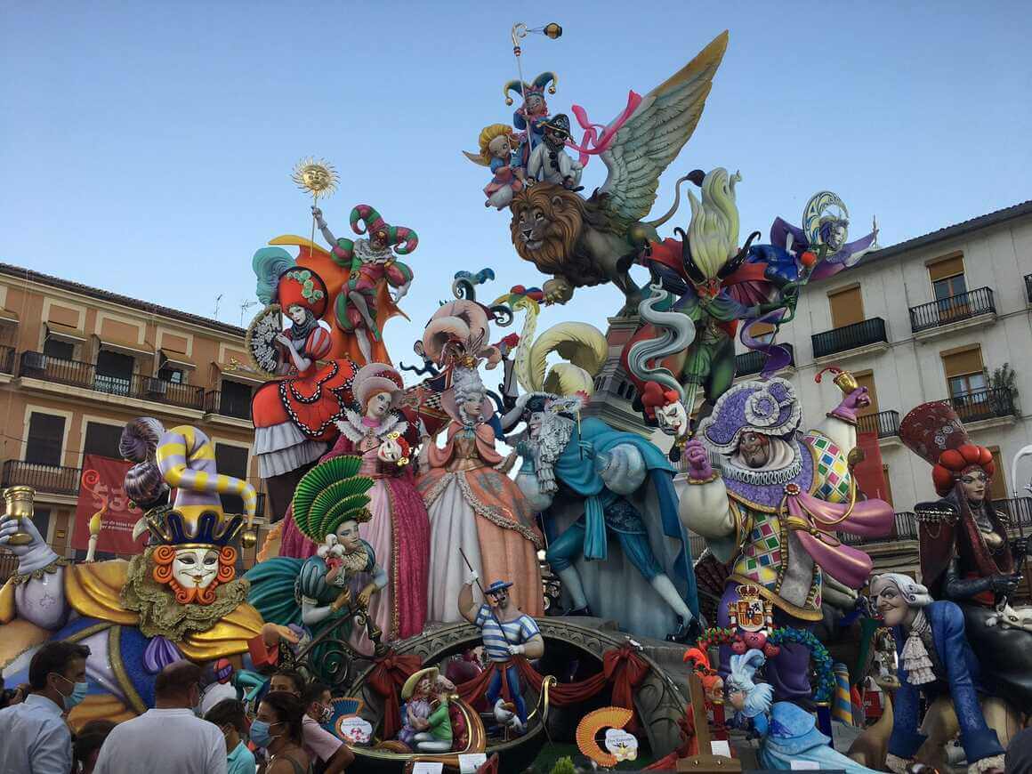 winning falla in 2021 at the festival of the Fallas in Valencia. Colourful people in masquerade dress