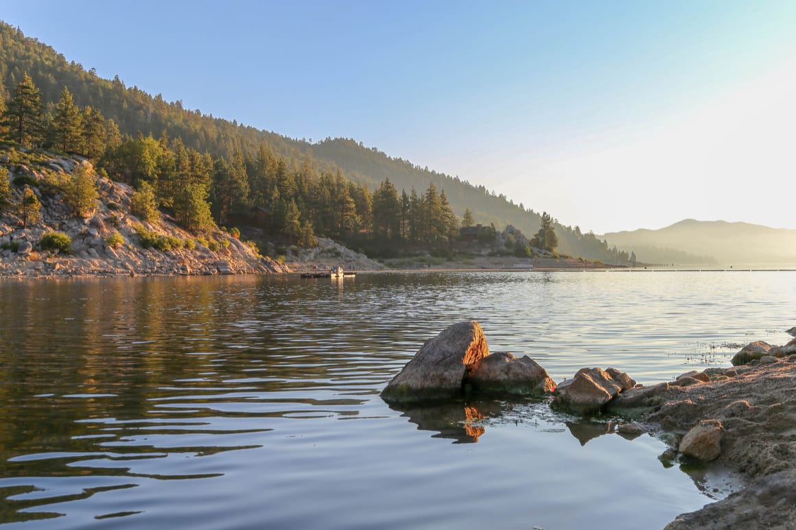 Big Bear Lake West at golden hour, rocky shores reflected in the lake