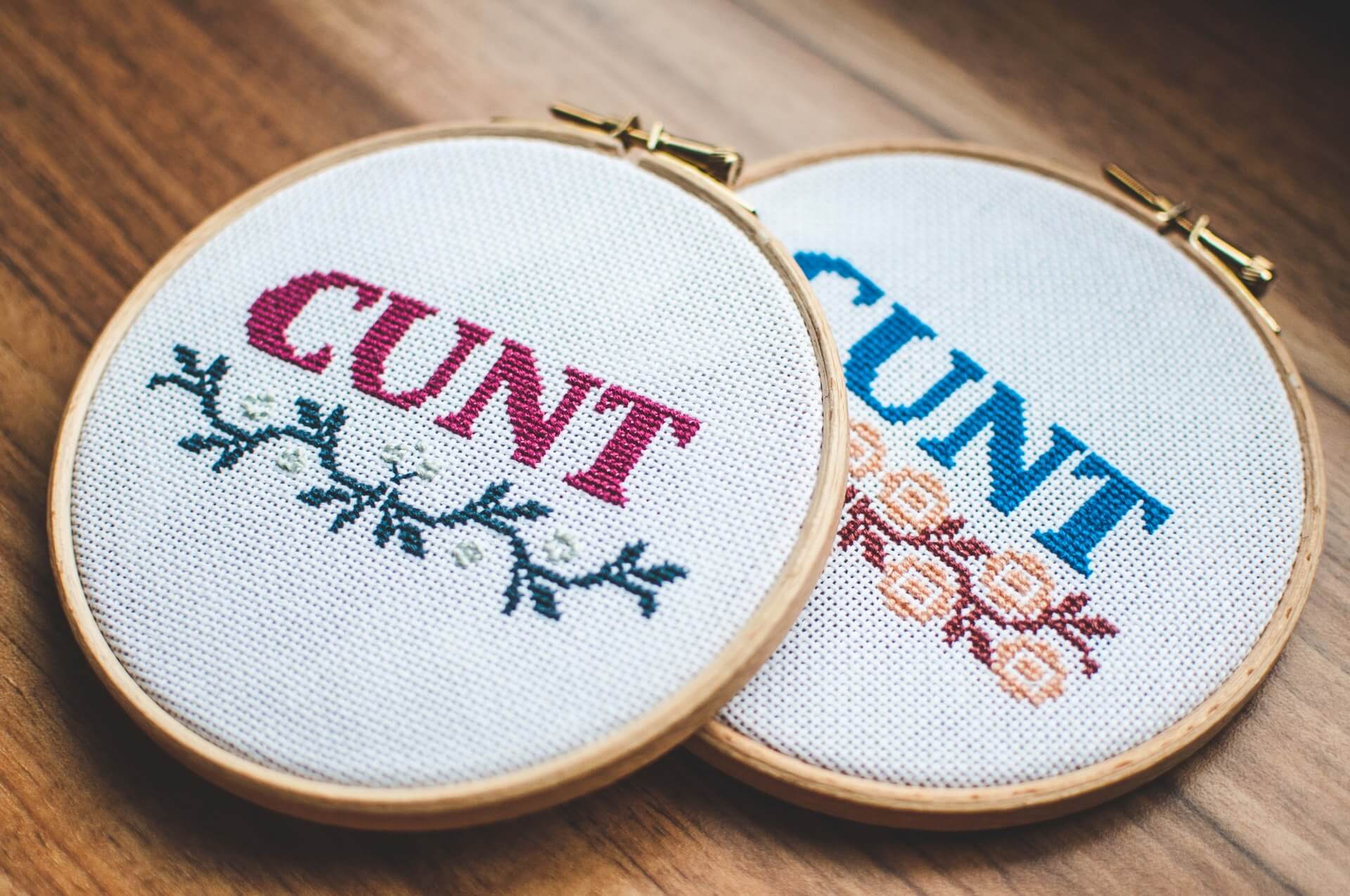 Two embroidered circles with the C-word written in them