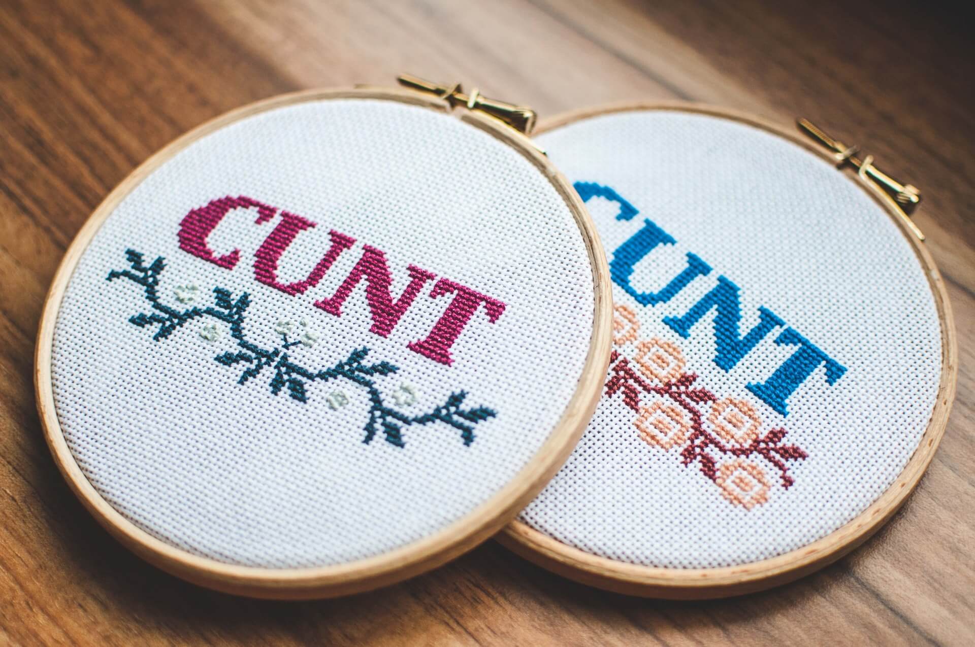 Two embroidered circles with the C-word written in them