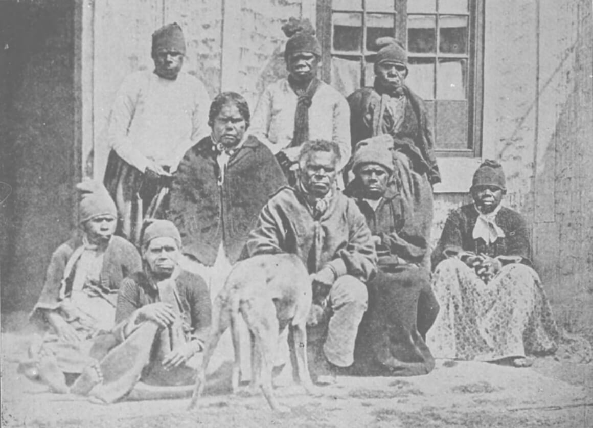 A historical photo of a group of indigenous Australians in colonial clothing