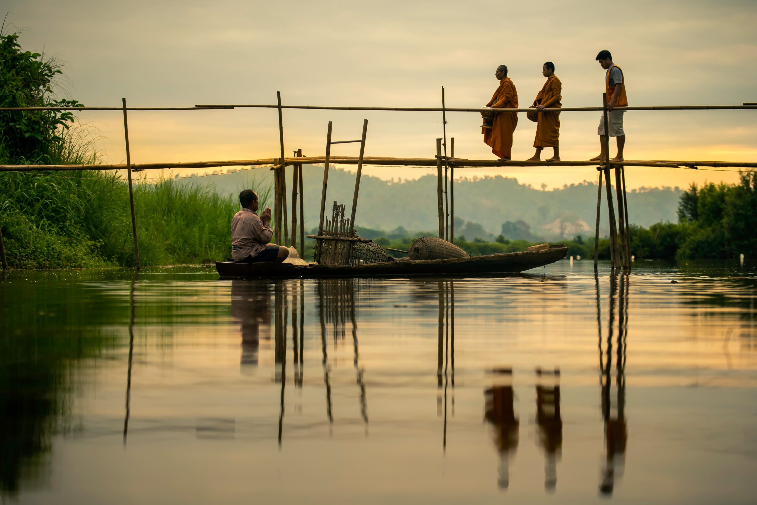 monks on a river in thailand