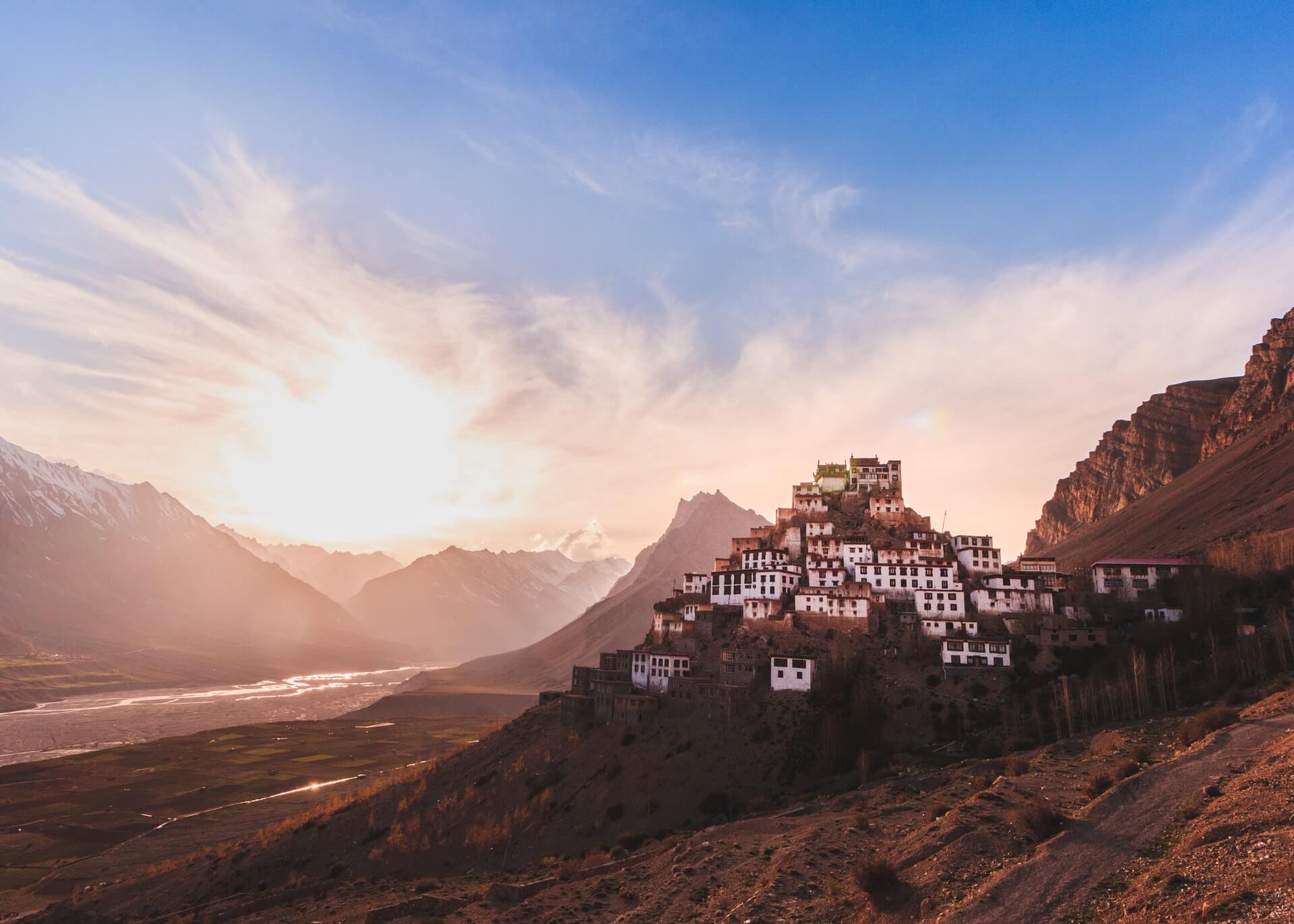 white buddhist monastery built into a hillside in india what is a homestay
